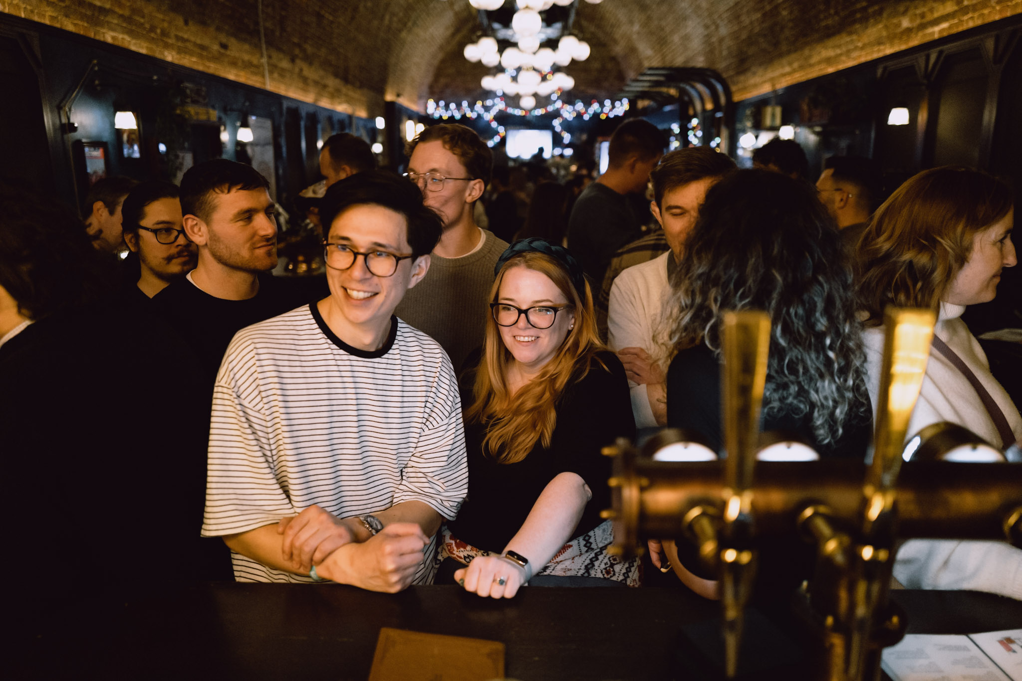 Company gathering — crowd shot, warm venue.